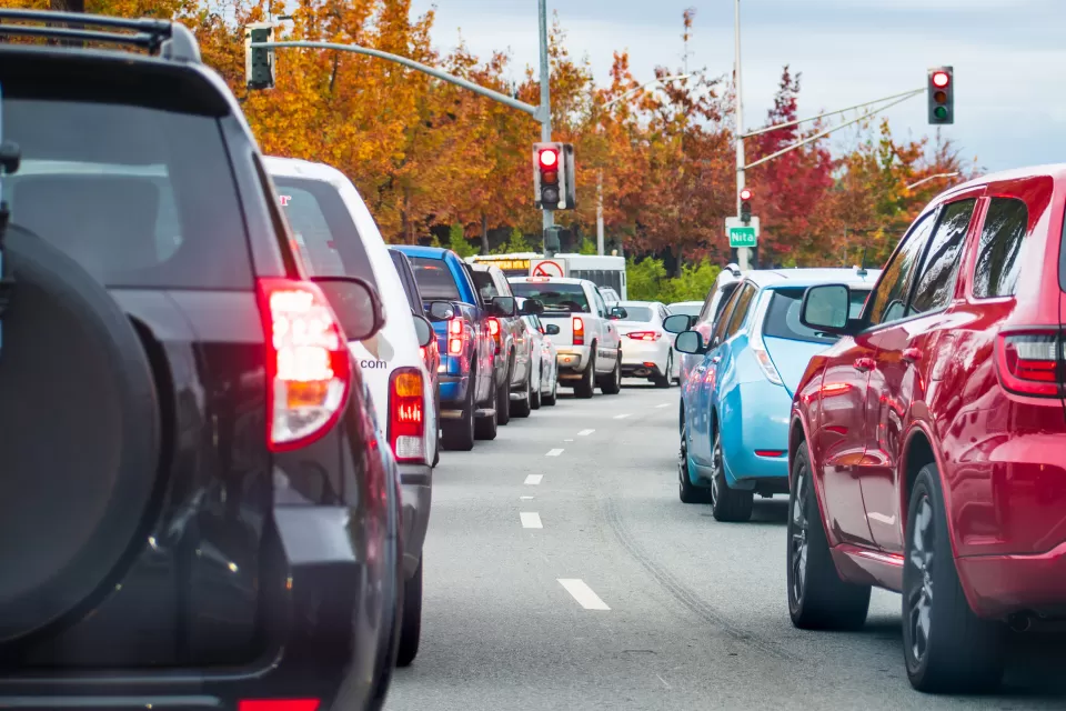 View of cars stuck in gridlocked traffic with traffic lights in background